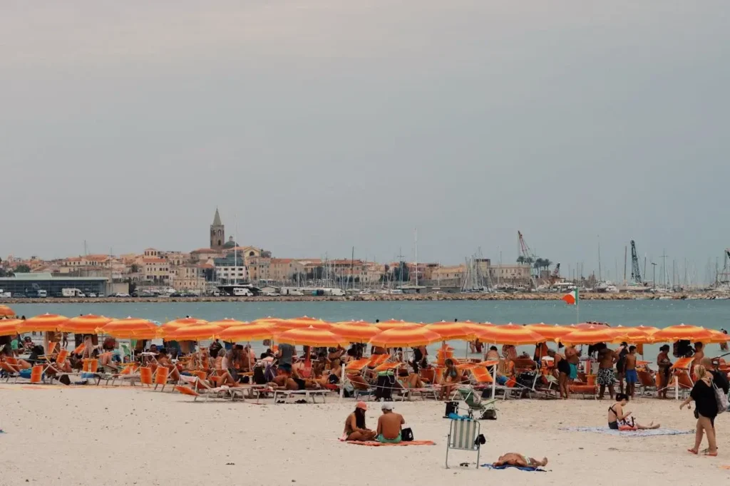 a group of people on a beach with umbrellas